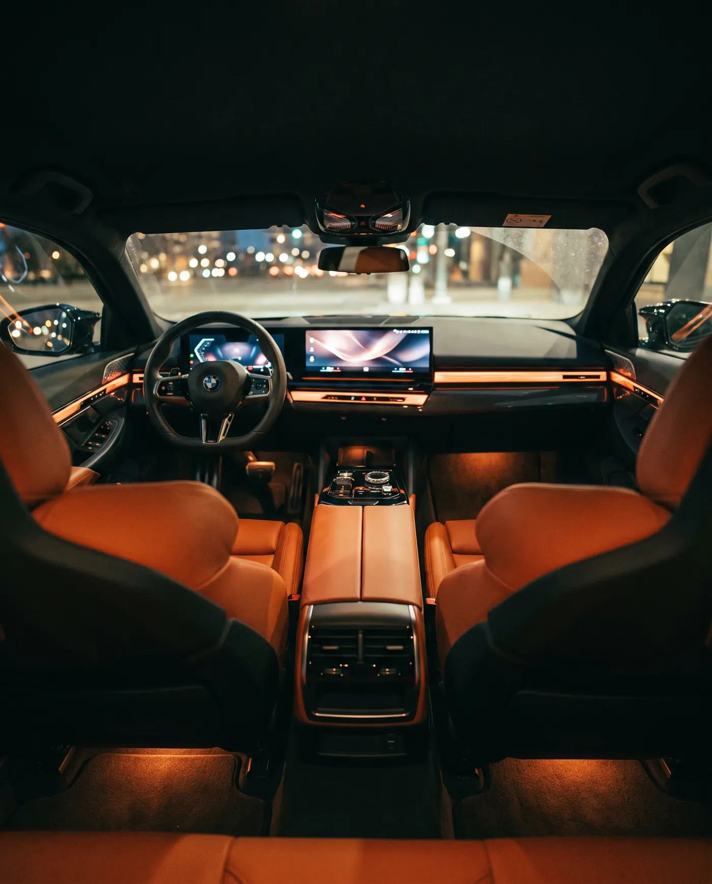 BMW M5 cabin at night with orange leather seats